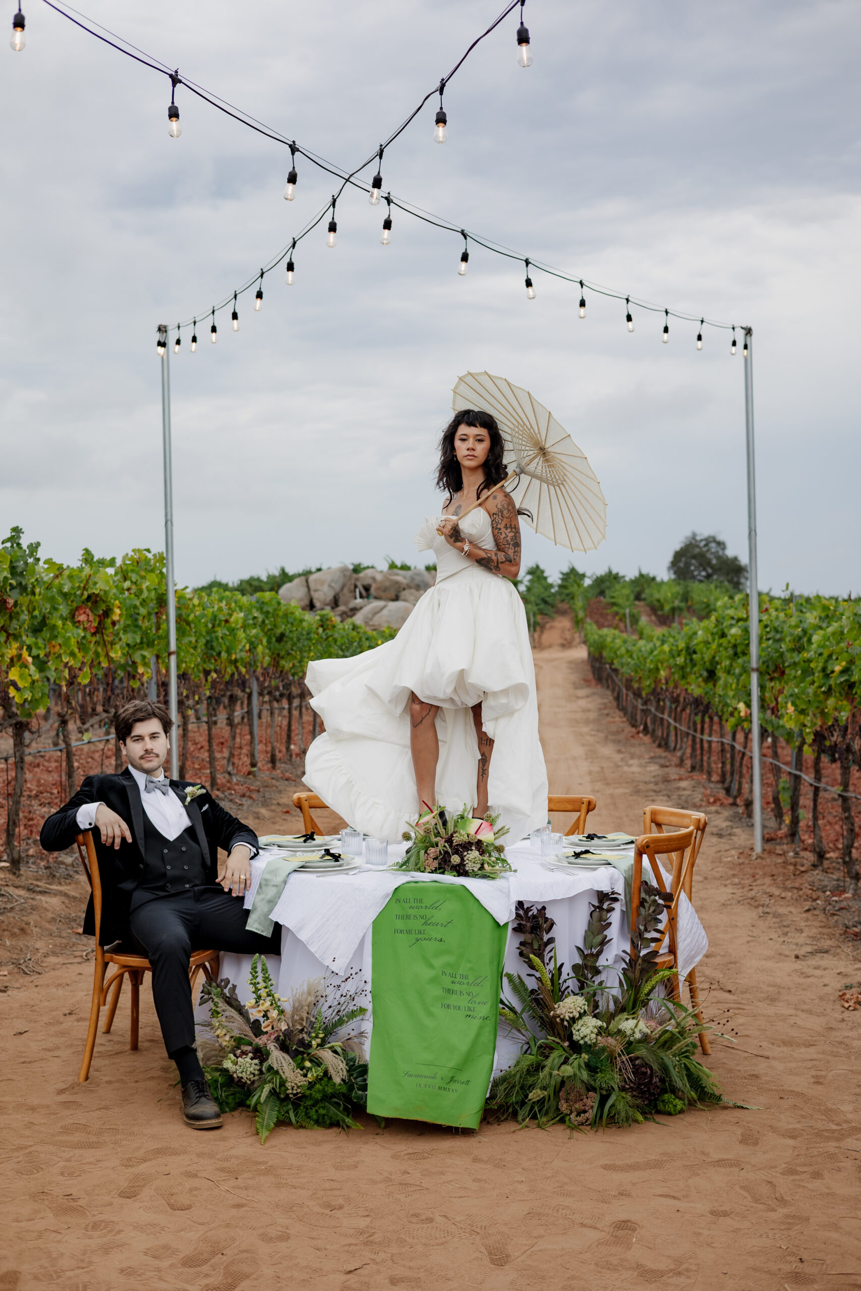 Styled fall wedding tablescape at a vineyard venue with string lights and seasonal wedding flowers October floral accents