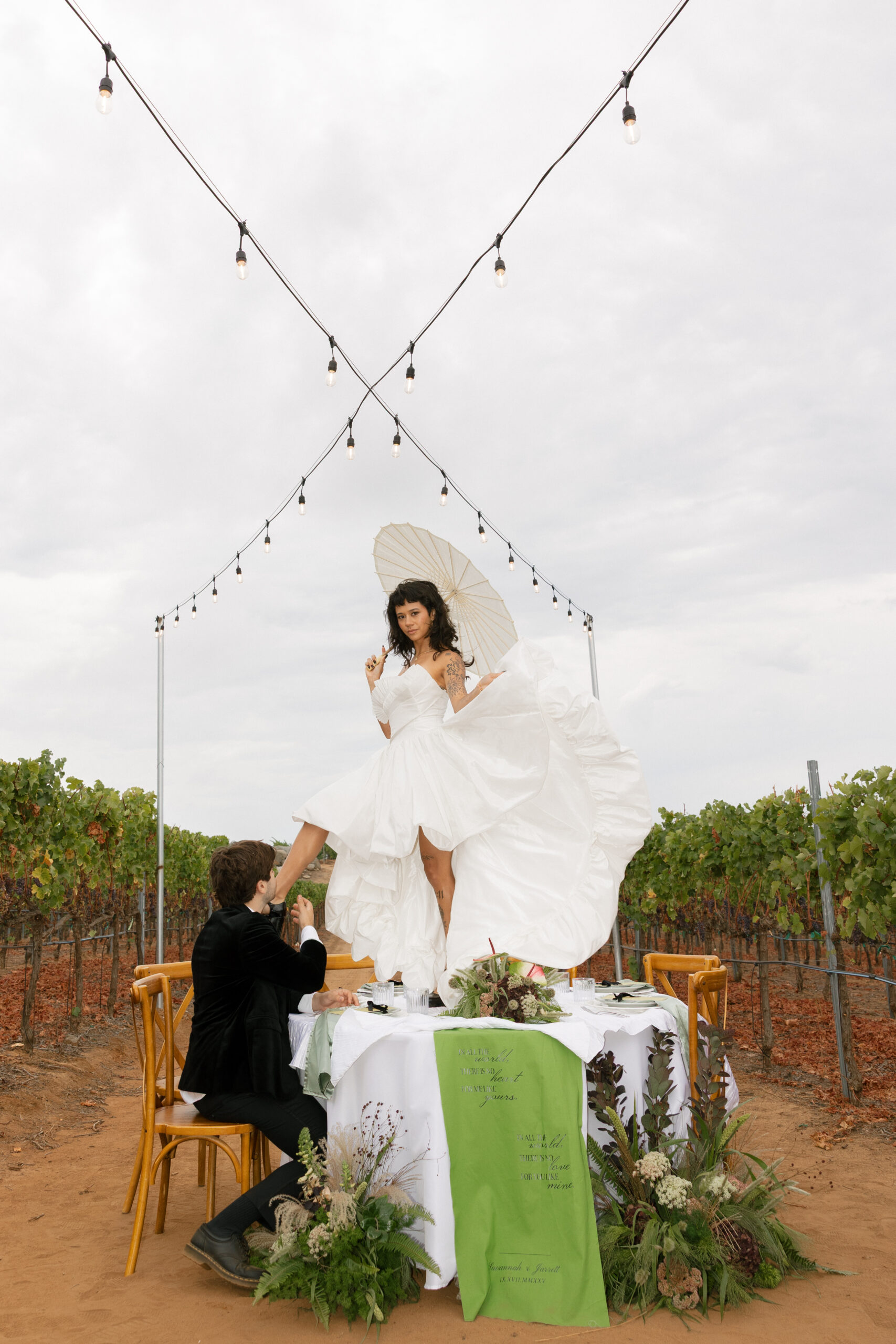 Vineyard reception scene with string lights, an example of seasonal wedding flowers October styling